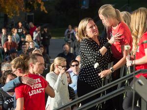 (Jeremy Harmon  |  The Salt Lake Tribune) Lauren McCluskey's parents, Matt and Jill McCluskey, hug some of their daughter's teammates after a vigil at the University of Utah on Wed. Oct 24, 2018.