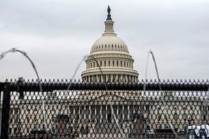 (Jose Luis Magana | AP file photo) The U.S. Capitol is seen through a fence with barbed wire during the second impeachment trial of former President Donald Trump in Washington, Friday, Feb. 12, 2021. Sen. Mike Lee is calling for Congress to tear down that fence, saying it sends the wrong message.