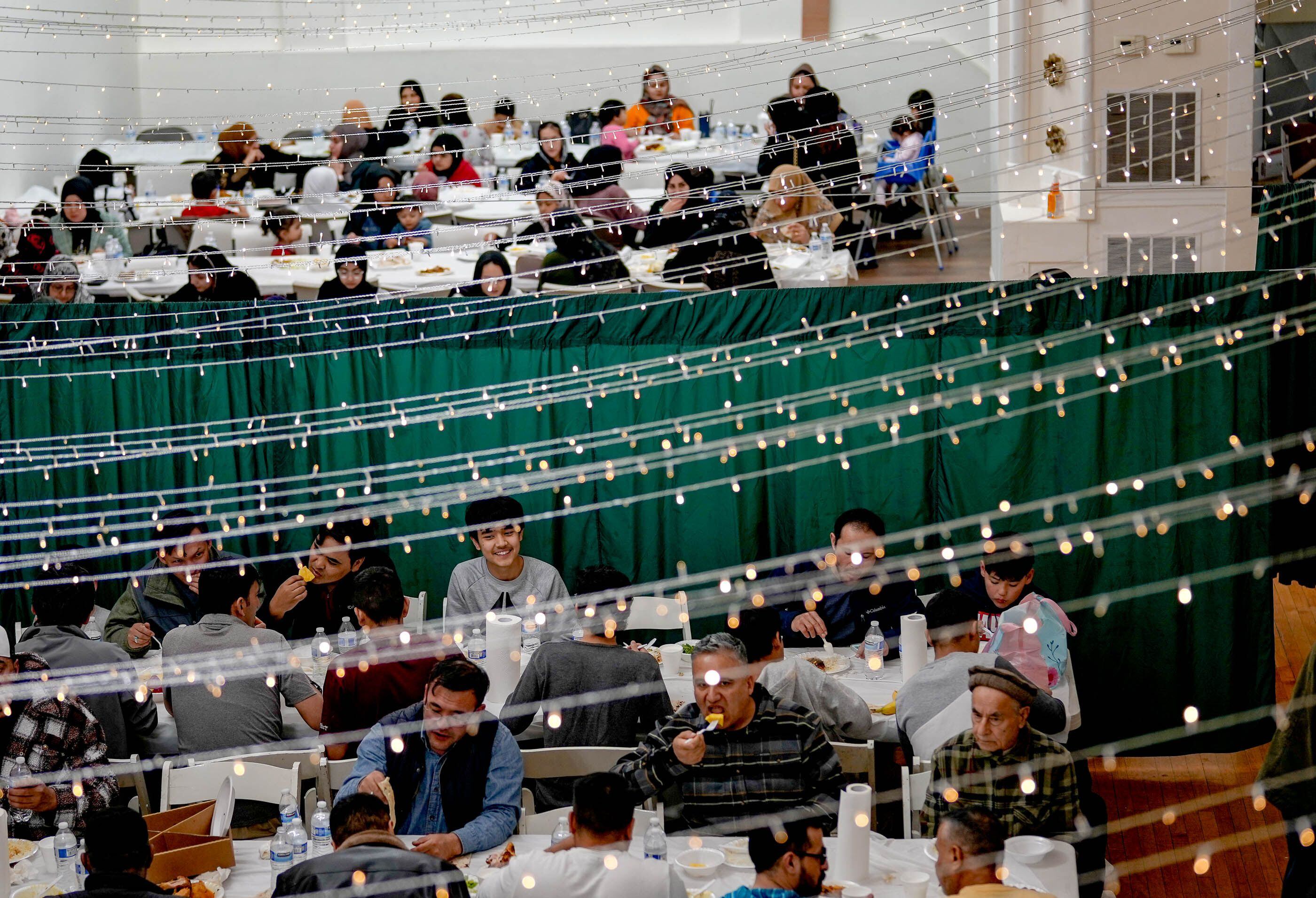 (Francisco Kjolseth | The Salt Lake Tribune) Men, women and children gather for an evening meal in the banquet hall at the Alrasool Islamic Center in Taylorsville during Ramadan, on Friday, March 22, 2024. 