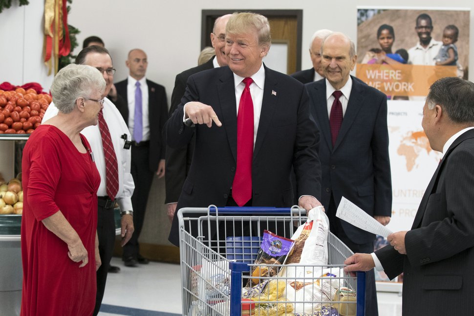 (AP file photo) President Donald Trump points to his shopping cart during a tour of The Church of Jesus Christ of Latter-day Saints' Welfare Square food distribution center, Monday, Dec. 4, 2017, in Salt Lake City. 