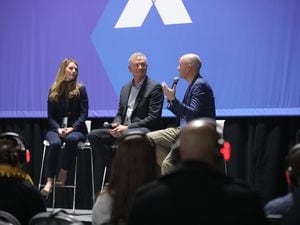 (Office of the Governor) Gov. Spencer Cox, right, talks with Chelsie Bright of Qualtrics, left, and Utah CIO Rich Saunders in a keynote at the X4 Summit at the Salt Palace Convention Center on March 8, 2023.