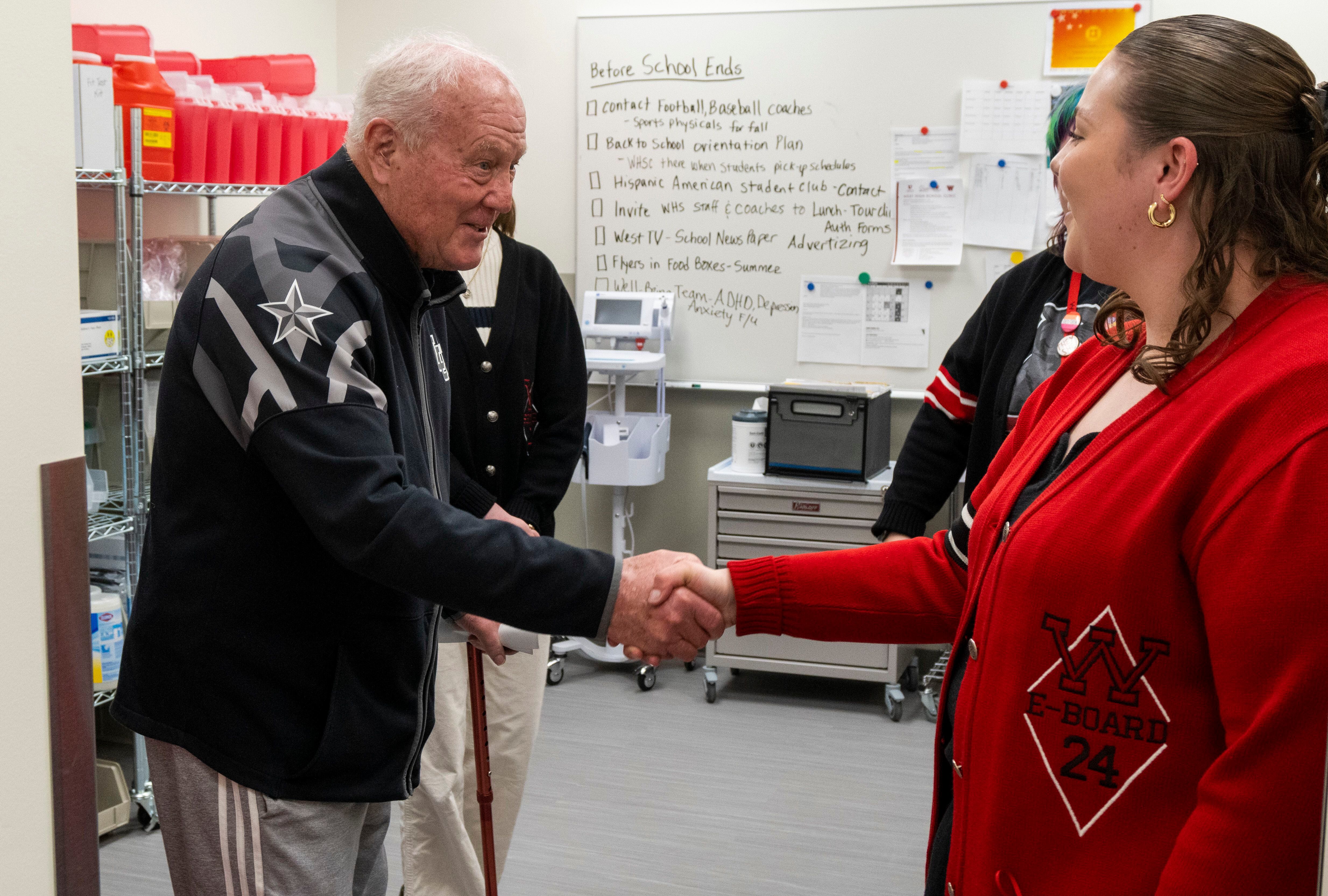 (Rick Egan | The Salt Lake Tribune) Former Utah coach Ron McBride visits with a West High Student, during a tour of the new health clinic at West High School, on Wednesday, March 20, 2024.
