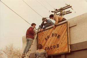 (Photo courtesy Abby Maestas) Four women help put up a sign at 20 Rue Jacob, a lesbian bookstore located at 200 East and 800 South, as it opened in Salt Lake City in 1979. The Rue, as it affectionately became known, was a women's-only space — part of the movement for feminist separatism from men that emerged around the time.