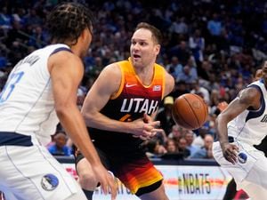 Utah Jazz forward Bojan Bogdanovic, center, loses control of the ball as Dallas Mavericks' Jalen Brunson, left, and Dorian Finney-Smith, right, defend in the first half of Game 2 of an NBA basketball first-round playoff series, Monday, April 18, 2022, in Dallas. (AP Photo/Tony Gutierrez)