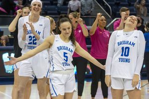 (Rick Egan | The Salt Lake Tribune) BYU Cougars center Sara Hamson (22) and BYU Cougars guard Tegan Graham (10) laugh as Maria Albiero (5) strikes a pose as BYU celebrates their win over the Pepperdine Waves this year. On Wednesday, the Cougars named Amber Whiting as the team's new head coach.