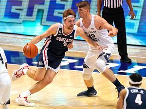 Gonzaga forward Drew Timme (2) drives as BYU center Richard Harward (42) defends in the first half of an NCAA college basketball game, Monday, Feb. 8, 2021, in Provo, Utah. (AP Photo/Rick Bowmer)