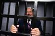 (Chris Samuels | The Salt Lake Tribune) Former Gov. Gary Herbert poses for a photograph of himself in a holding cell during a tour the Wasatch Block of the former Utah State Prison in Draper, Monday, Aug. 15, 2022.