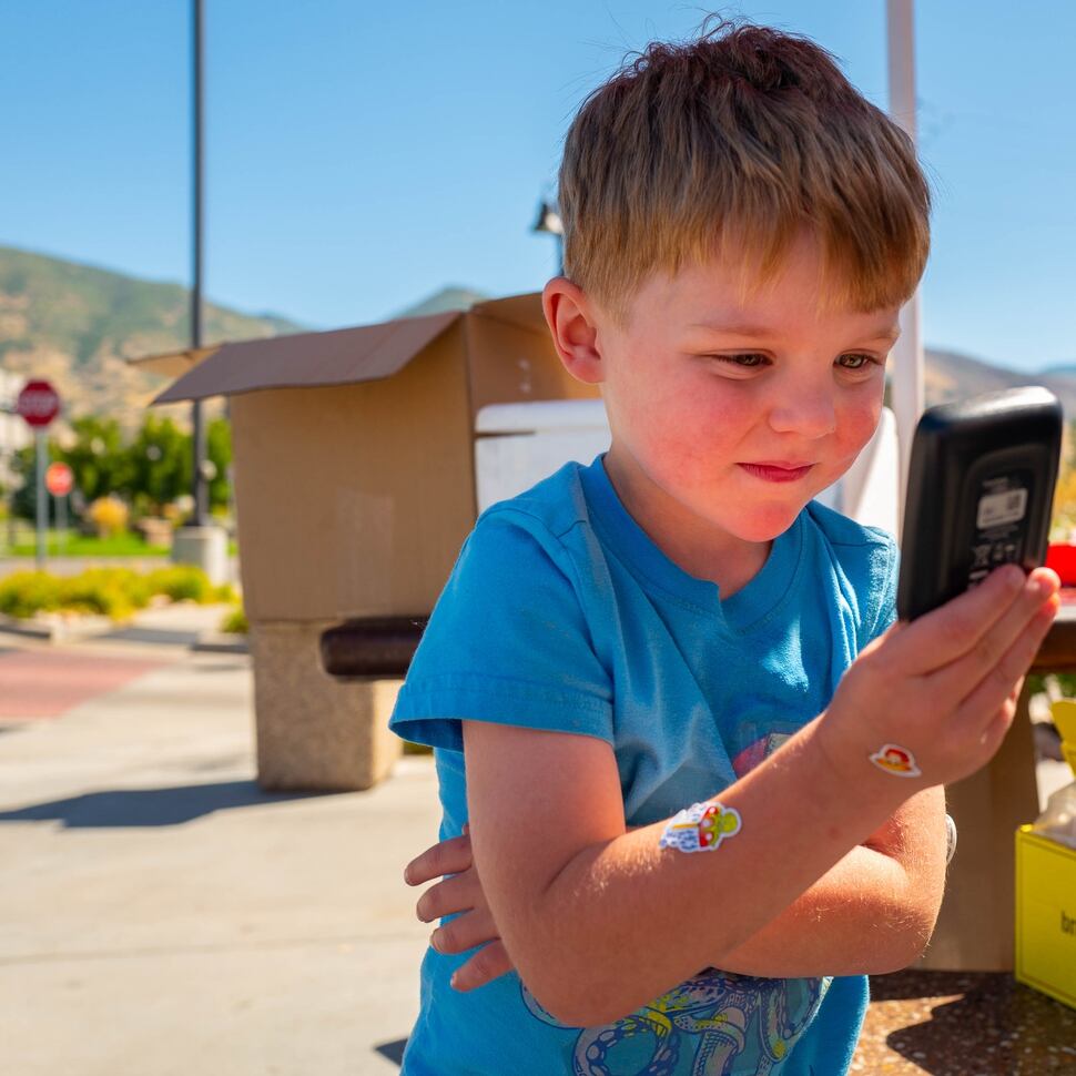 (Trent Nelson | The Salt Lake Tribune) Darwin Cram, 4, checks his blood sugar levels in Centerville on Friday Sept. 13, 2019.