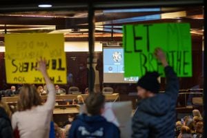 (Trent Nelson  |  The Salt Lake Tribune) People gather as the Salt Lake County Council holds a brief meeting on the mask mandate, in Salt Lake City on Thursday, Jan. 13, 2022.