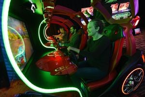(Francisco Kjolseth  |  The Salt Lake Tribune)  Andie Saunders joins friends as they play the Cruis'n Blast driving game as Dave & Buster's restaurant and entertainment business hosts a VIP event on Thursday, May 10, 2018, at its new Salt Lake City venue at The Gateway before officially opening to the public on Monday, May 14.