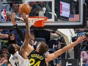 (Rick Egan | The Salt Lake Tribune) Brooklyn Nets guard Kyrie Irving (11) goes in for a dunk, as Utah Jazz center Walker Kessler (24) gets tangled up in the net, in NBA action between the Utah Jazz and the Brooklyn Nets at Vivint Arena, on Friday, Jan. 20, 2023.