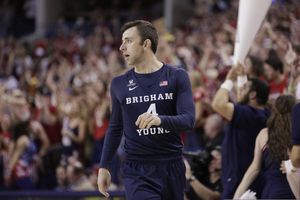 FILe - In this Feb. 25, 2017, file photo, BYU guard Nick Emery walks on the court during the first half of an NCAA college basketball game against Gonzaga in Spokane, Wash. The men’s basketball program at Brigham Young University must vacate wins over two seasons and received two years of probation from the NCAA after one of its players received extra benefits. The NCAA said Friday, Nov. 9, 2018, that Nick Emery received more than $12,000 in benefits from four boosters, which included travel to concerts and an amusement park along with the use of a new car.  (AP Photo/Young Kwak, File)