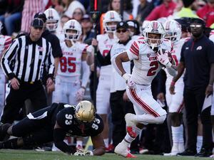 Utah running back Micah Bernard, right, heads up the sideline after pulling in a pass in front of Colorado defensive lineman Ryan Williams in the first half of an NCAA college football game Saturday, Nov. 26, 2022, in Boulder, Colo. (AP Photo/David Zalubowski)
