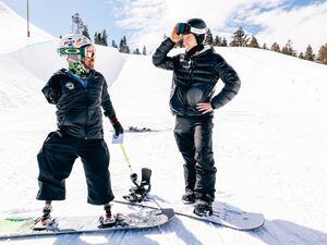 (Sean Ryan| CAF) Zach Sherman, a triple amputee, snowboards at Woodward Park City on March 15, 2022. Olympian Shaun White joined Sherman for a few runs and presented him with a grant from the Challenged Athlete Foundation.