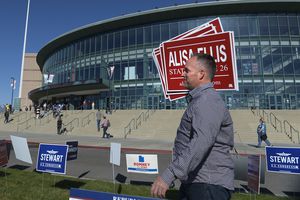 (Leah Hogsten  |  Tribune file photo) Dan Ellis of Heber City carries signs for his wife Alisa Ellis, a candidate for state Senate at the 2018 Utah Republican State Convention, April 21, 2018, at the Maverik Center in West Valley City.