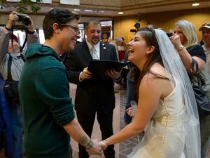Francisco Kjolseth  |  The Salt Lake Tribune
Jax Collins, left, and Heather Collins are overjoyed as they are married by Rev. Christopher Scuderi of Universal Heart Ministry on Monday, Dec. 23, 2013, at the Salt Lake City County offices.