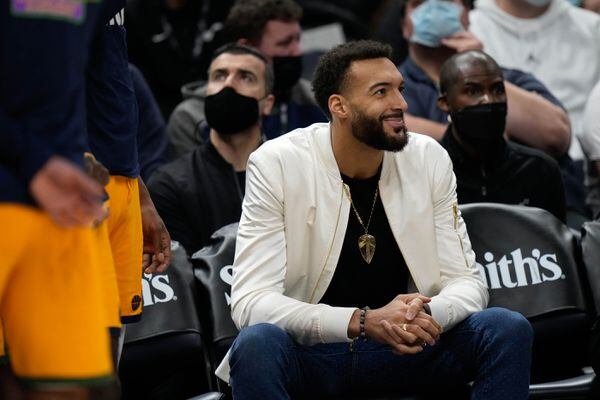 (Francisco Kjolseth | The Salt Lake Tribune) Utah Jazz center Rudy Gobert (27) supports his team from the sidelines as the Utah Jazz and the New York Nicks play an NBA basketball game at Vivint Arena in Salt Lake City on Monday, Feb. 7, 2022. When Gobert returns to Vivint Arena for the first time after being traded by the Jazz, fans will welcome him with a standing ovation. But, for how long?