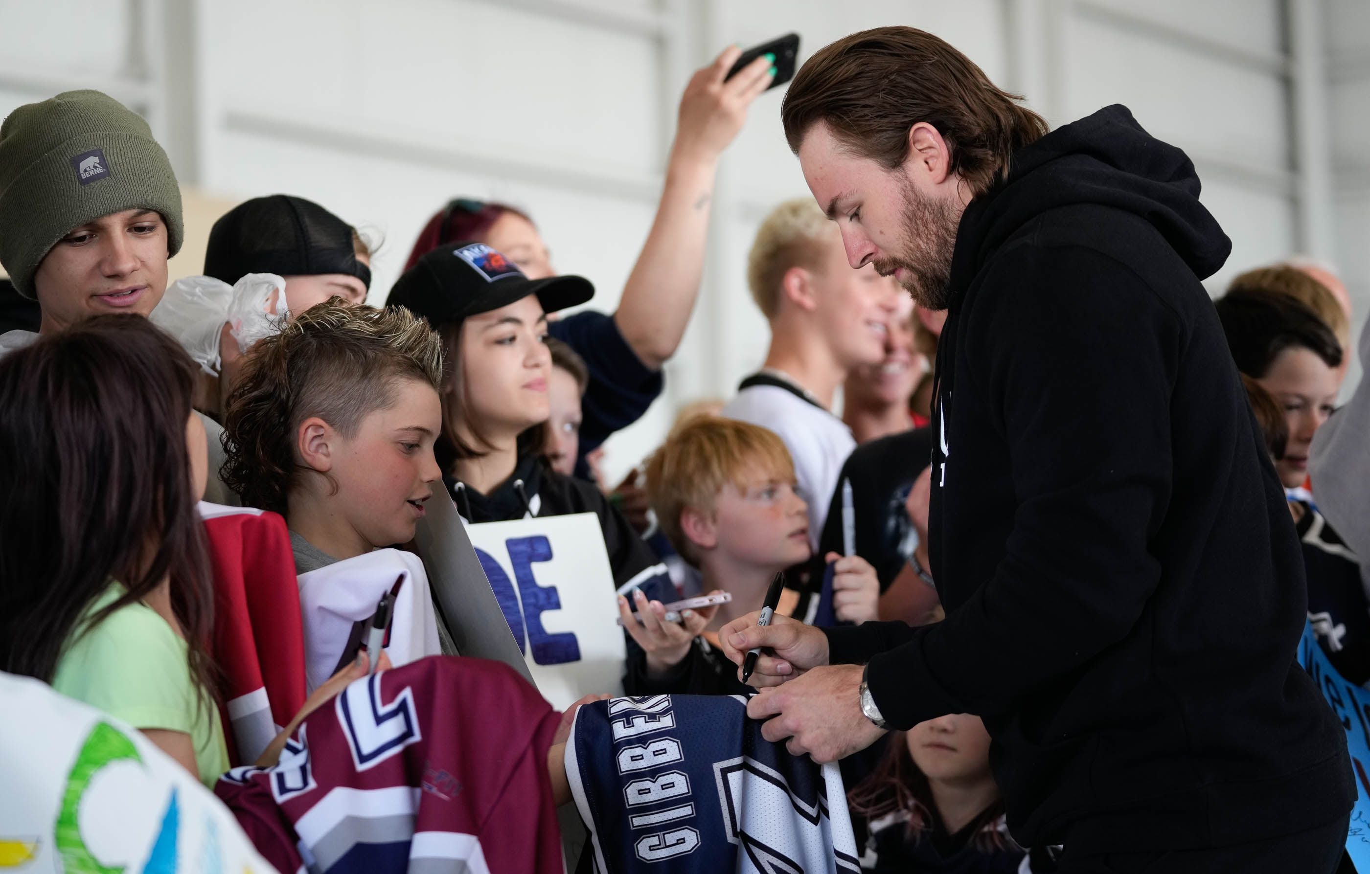 (Francisco Kjolseth  |  The Salt Lake Tribune) Michael Carcone signs autographs for young hockey fans at Utah’s new NHL hockey team arrives in Salt Lake City on Wednesday, April 24, 2024.