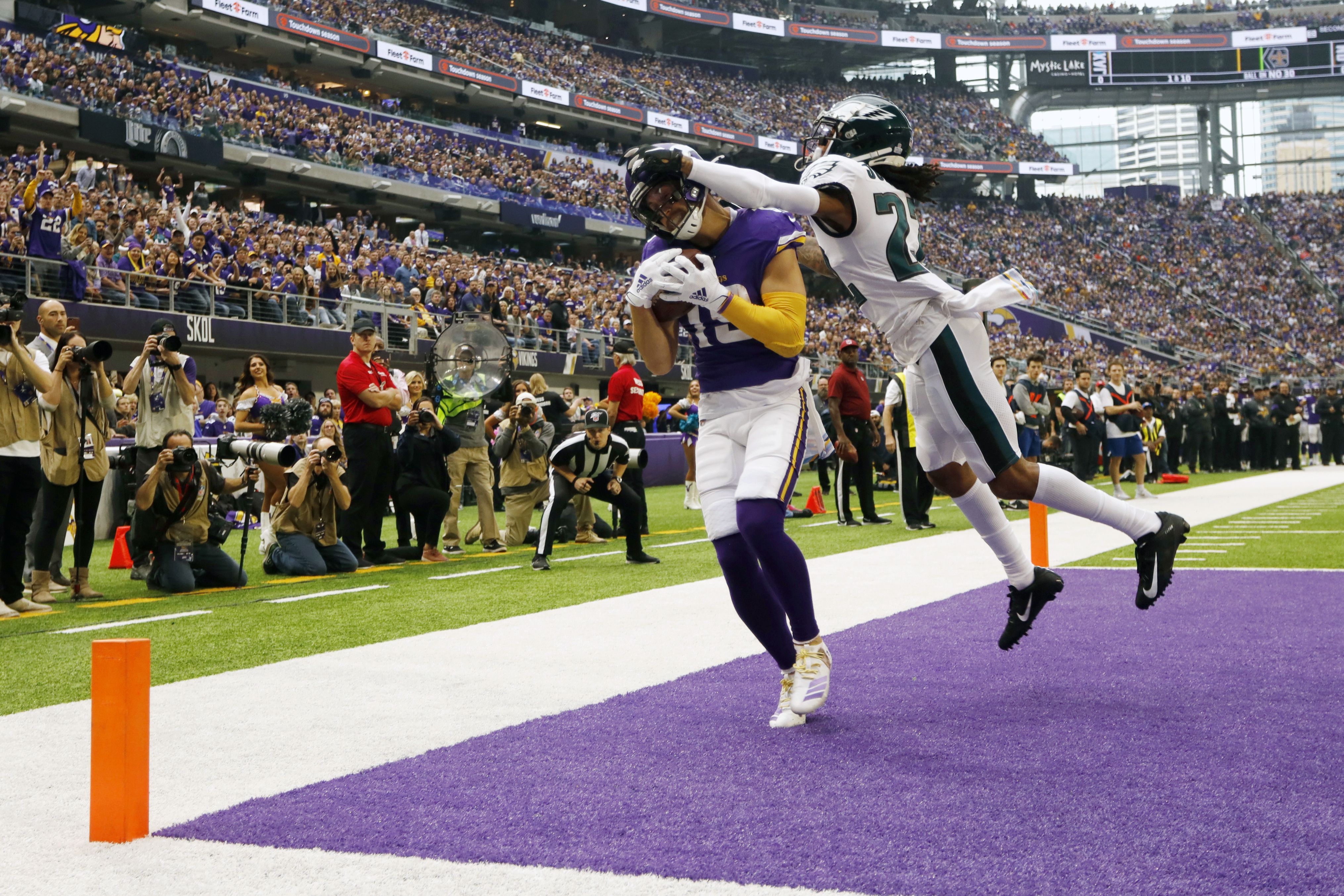 Minnesota Vikings wide receiver Adam Thielen catches a touchdown pass in front of Philadelphia Eagles cornerback Sidney Jones, right, during the first half of an NFL football game, Sunday, Oct. 13, 2019, in Minneapolis. (AP Photo/Bruce Kluckhohn)
