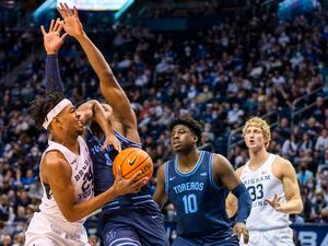 Rick Egan | The Salt Lake Tribune)  San Diego Toreros forward Josh Parrish (4) is called for a foul as he collides with Brigham Young Cougars forward Seneca Knight (24), in basketball action at the Marriott Center, on Thursday, January 20, 2022.