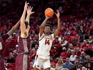 Arkansas guard Jaxson Robinson (14) shoots over an Arkansas-Little Rock defender during the first half of an NCAA college basketball game Saturday, Dec. 4, 2021, in Fayetteville, Ark. (AP Photo/Michael Woods)