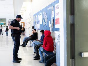 (Rachel Rydalch | The Salt Lake Tribune) Hunter High School Student Resource Officer Brandon White interacts with students as a school day ends on Thursday, March 24, 2022.