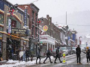 (Francisco Kjolseth | The Salt Lake Tribune) People visit historic Main Street in Park City on Thursday, Dec. 30, 2021. Sundance Film Festival on Wednesday, Jan. 5, 2022, canceled planned in-person screenings for the January event amid a recent spike in COVID-19 cases.