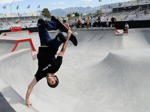 (Francisco Kjolseth  |  The Salt Lake Tribune)  Skate legend Tony Hawk delights the crowd with an invert as he joins other pro skaters for a community skate during a first look of the new Vans - Utah Sports Commission Skatepark at the Utah State Fairpark on Tuesday, Sept. 3, 2019. The skatepark has a street course, but Hawk brought his inaugural Vert Alert halfpipe event to the Fairpark last year and plans to return in August 2022.