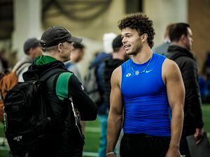 (Nate Edwards | BYU) Quarterback Jaren Hall talks with a New York Jets scout at BYU's pro day on March 24, 2023.