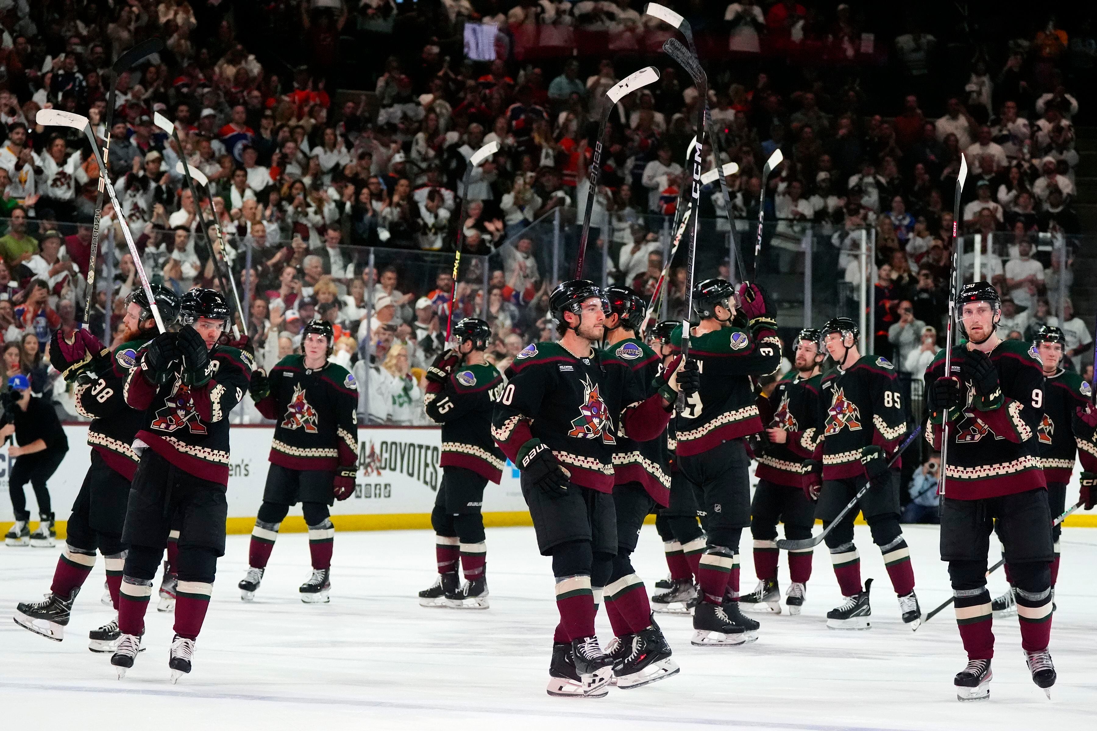 (Ross D. Franklin | AP) Arizona Coyotes players acknowledge the fans after the final whistle in Tempe Wednesday. Team owner Alex Meruelo agreed to sell franchise's hockey operations to Utah Jazz owner Ryan Smith, who intends to move the team to Salt Lake City.