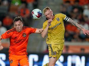 (David J. Phillip | AP) Real Salt Lake's Justen Glad, right, head the ball past Houston Dynamo's Corey Baird during the first half of an MLS soccer match Saturday, May 6, 2023, in Houston.