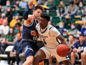 Colorado State guard Isaiah Stevens (4) bumps Utah State guard Rylan Jones (15) during the first half of an NCAA college basketball game Wednesday, Jan. 12, 2022, in Fort Collins, Colo. (AP Photo/Jack Dempsey)