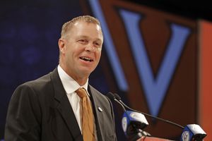 RETRANSMISSION TO CORRECT SCHOOL TO VIRGINIA - Virginia head coach Bronco Mendenhall answers a question during a news conference at the NCAA Atlantic Coast Conference college football media day in Charlotte, N.C., Wednesday, July 18, 2018. (AP Photo/Chuck Burton)