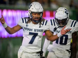 Utah State quarterback Bishop Davenport reacts after scoring a touchdown against Colorado State during the third quarter of an NCAA college football game in Fort Collins, Colo., Saturday, Oct. 15, 2022. (Jon Austria/The Coloradoan via AP)