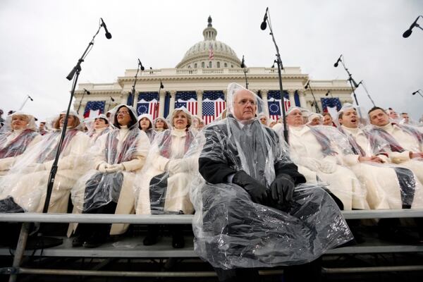 Music director Mack Wilberg, front, and members of the Mormon Tabernacle Choir sit in the rain waiting for the swearing in of Donald Trump as the 45th president of the United States to begin during the 58th Presidential Inauguration at the U.S. Capitol in Washington. Friday, Jan. 20, 2017 (AP Photo/Carolyn Kaster)