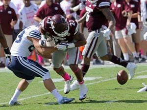 (Jim Lytle | AP) BYU place kicker Andrew Mikkelsen (83) forces Mississippi State wide receiver Keith Mixon (23) to fumble the ball during the second half of an NCAA college football game in Starkville, Miss., Saturday, Oct. 14, 2017. Mississippi State won 35-10.