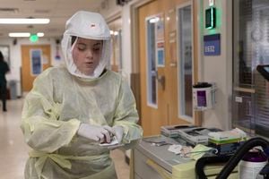 (Intermountain Healthcare) A nurse dons personal protective equipment while treating patients infected with COVID-19 at Intermountain's LDS Hospital, Feb. 3, 2022.