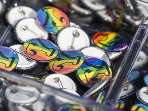 (Rick Egan | The Salt Lake Tribune) Rainbow "Y" pins at a booth at Kiwanis Park, during Pride Night in Provo organized by BYU students, on Saturday, Sept. 4, 2021. There's a new social media movement to support LGBTQ students at the private Utah school owned by The Church of Jesus Christ of Latter-day Saints in June 2022.