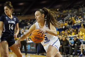 BYU guard Maria Albiero (5) drives as Villanova forward Brianna Herlihy (14) defends during the second half of a college basketball game in the first round of the NCAA tournament, Saturday, March 19, 2022, in Ann Arbor, Mich. (AP Photo/Carlos Osorio)