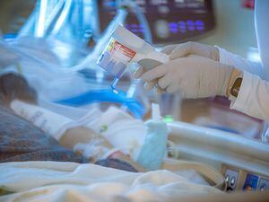 (Charlie Ehlert | University of Utah Health) A health care worker attends to a patient in the intensive care unit at University Hospital in Salt Lake City, Wednesday, March 9, 2022.