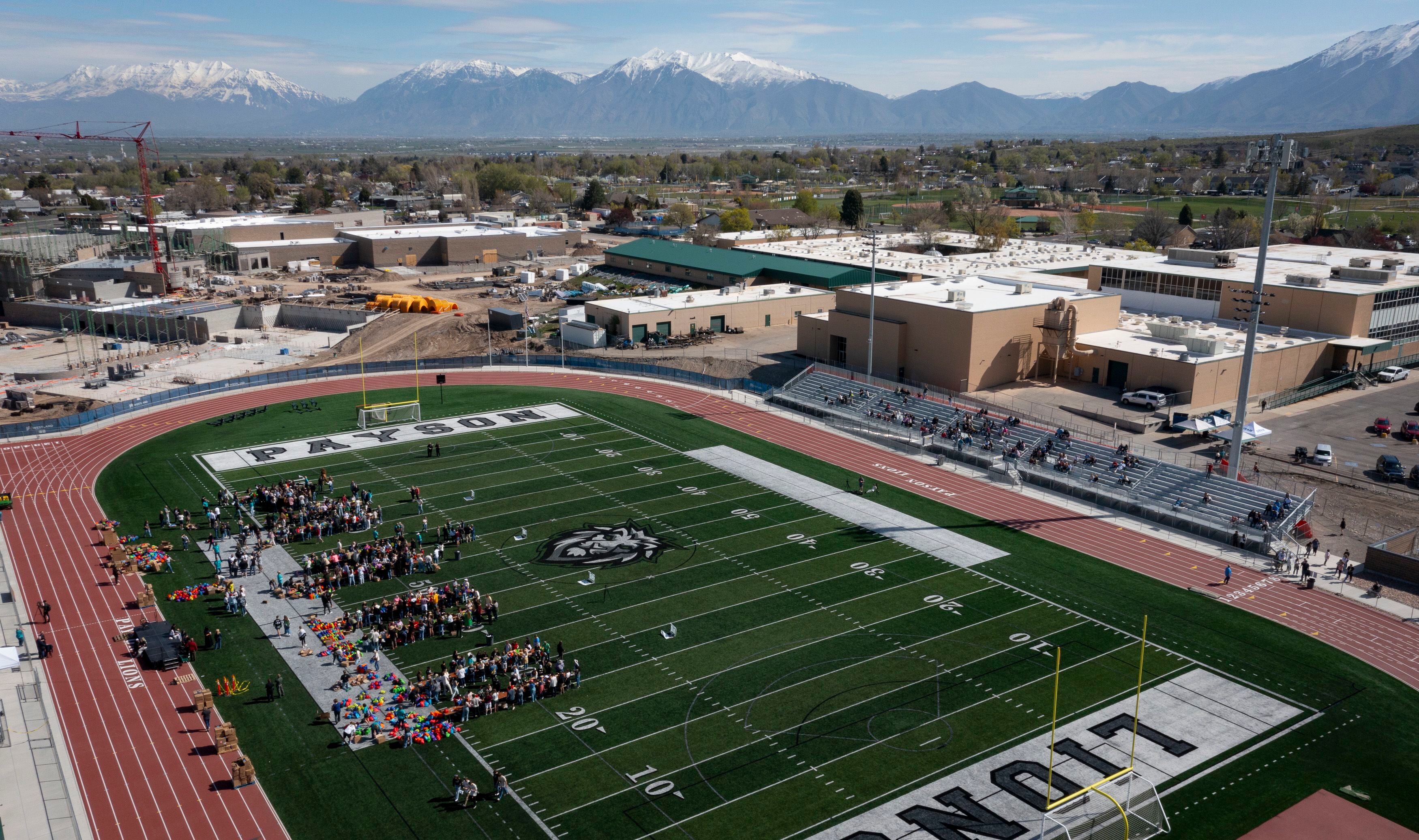 (Bethany Baker  |  The Salt Lake Tribune) Students and volunteers pack resource kits for Kevin Bacon’s nonprofit SixDegrees at a charity event to commemorate the 40th anniversary of the movie “Footloose” on the football field of Payson High School in Payson on Saturday, April 20, 2024.