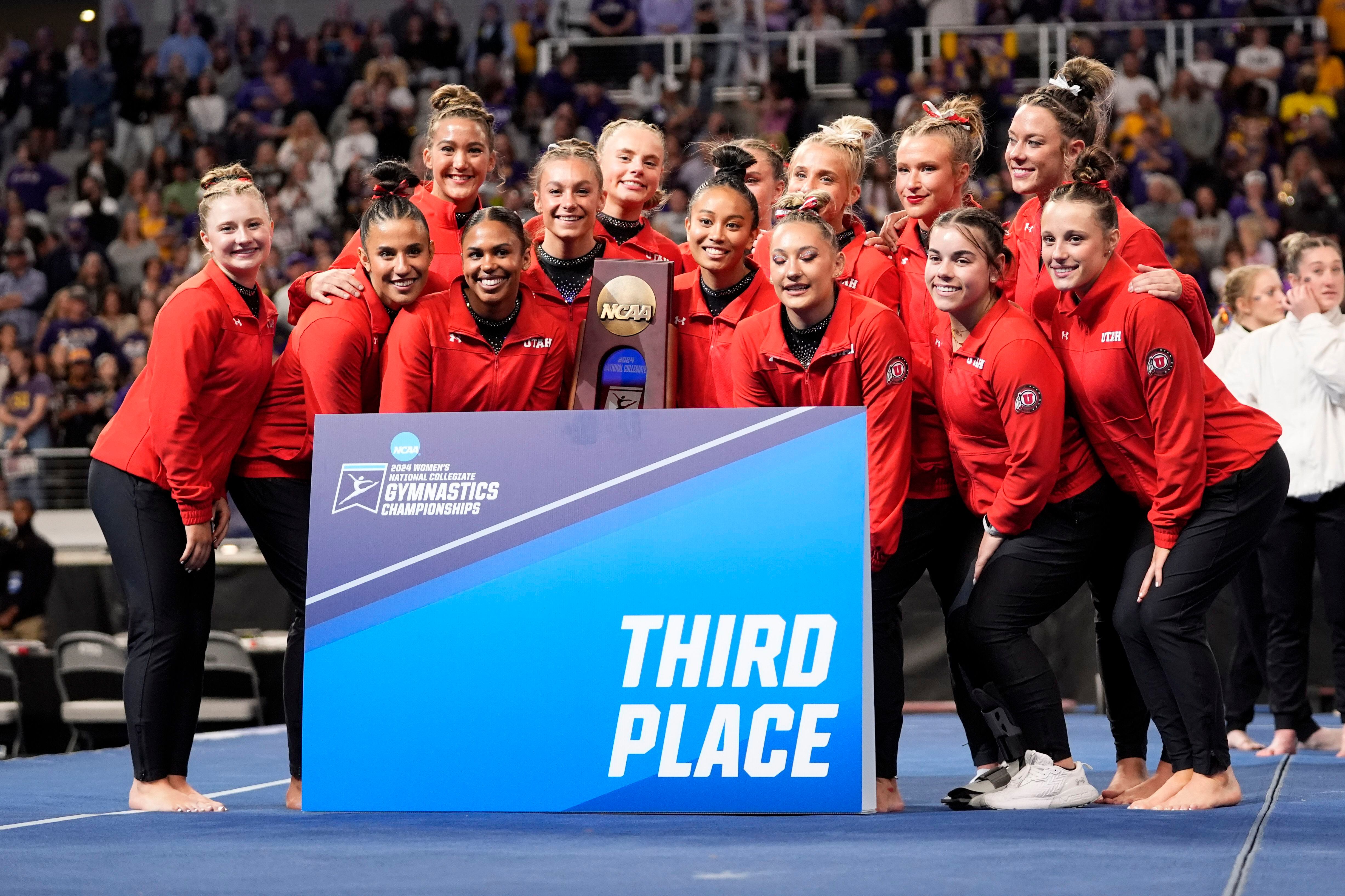 (Tony Gutierrez | AP) Utah competitors pose for photos after taking third place in the NCAA women's gymnastics championships in Fort Worth, Texas, Saturday, April 20, 2024.