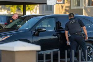 (Rick Egan | The Salt Lake Tribune) Salt Lake City Police look through car windows as they investigate a shooting at the Pebble Creek Apartments on 1700 South, where one person was killed and two were injured, on Monday, June 6, 2022.