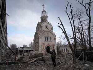 (Evgeniy Maloletka | AP) A Ukrainian serviceman takes a photograph of a damaged church after shelling in a residential district in Mariupol, Ukraine, Thursday, March 10, 2022. A U.S. State Department reports on religious freedom laments Russia's destruction of churches in Ukraine.