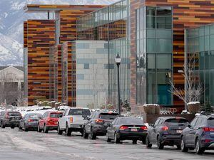 (Francisco Kjolseth | The Salt Lake Tribune) Long lines of cars snake around West Jordan City Hall and past the adjacent West Jordan Library on Tuesday, Jan. 4, 2022, as people wait for COVID-19 testing.