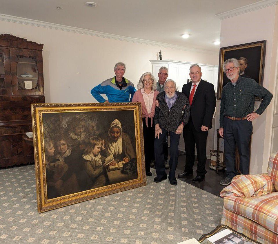 (FBI) Special Agent Gary France, second from right, joins Dr. Francis Wood and Wood’s children next to the John Opie painting that was stolen from Wood’s parents' home in 1969.