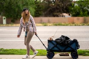 (Rick Egan | The Salt Lake Tribune) Maddison Hackford pulls her belongings along Redwood Road. Hackford has been living on the streets for the past six years, Wednesday, June 22, 2022.