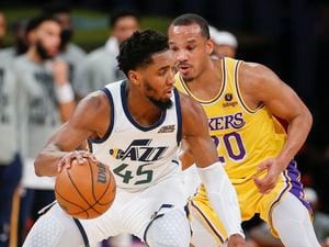 Utah Jazz guard Donovan Mitchell (45) is defended by Los Angeles Lakers guard Avery Bradley (20) during the second half of an NBA basketball game in Los Angeles, Monday, Jan. 17, 2022. The Lakers won 101-95. (AP Photo/Ringo H.W. Chiu)