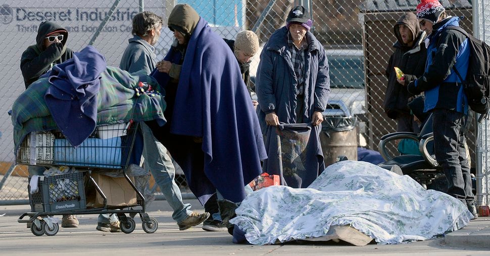 (Al Hartmann | Tribune file photo) Homeless people gather on 500 West near the Road Home shelter on Wednesday, Dec. 7, 2016.