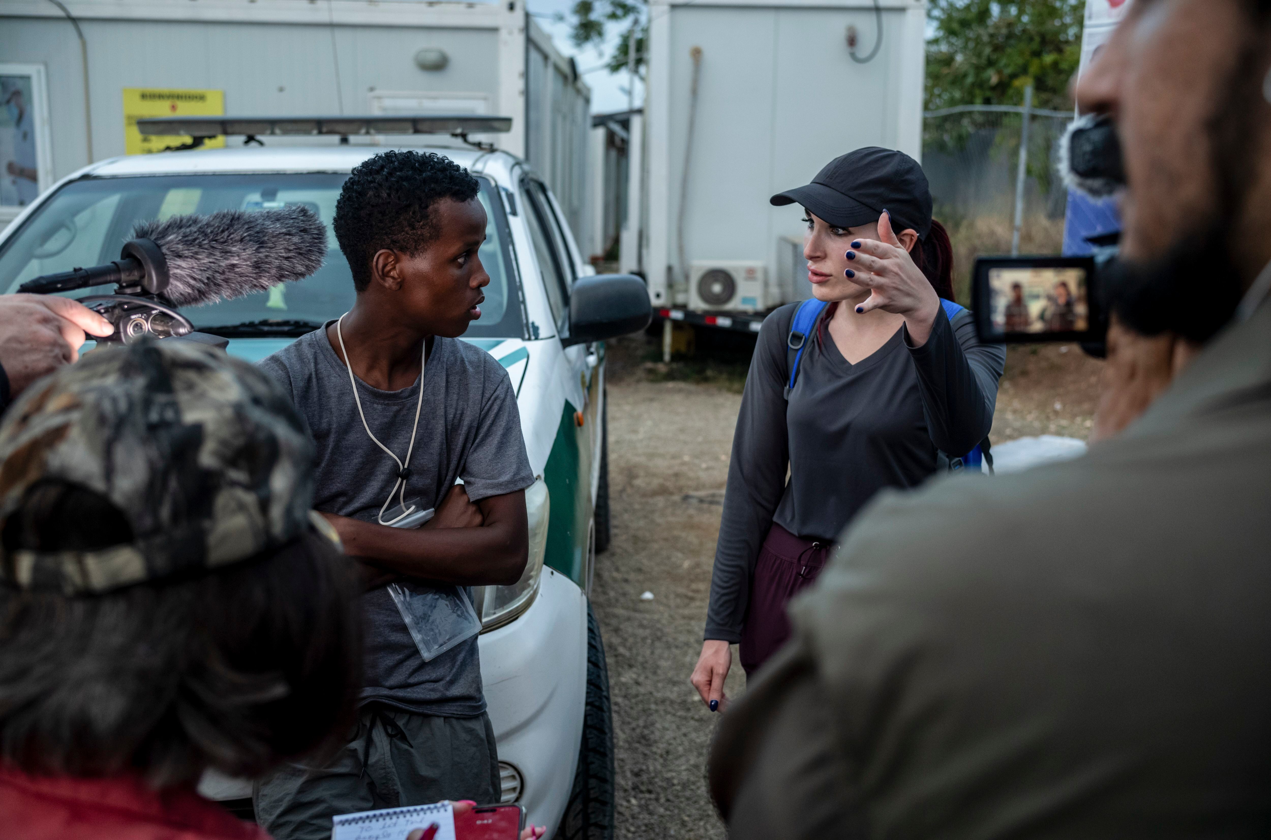 (Federico Rios | The New York Times) Laura Loomer, a right-wing activist, interviews Ayub, a Somalian migrant who is crossing the Darien Gap, at the Migrant Reception Center of San Vicente, Meteti, Panama, on Feb. 17, 2024. The treacherous migrant crossing in Panama is drawing packs of American activists who are distorting how immigration is perceived and debated at home.
